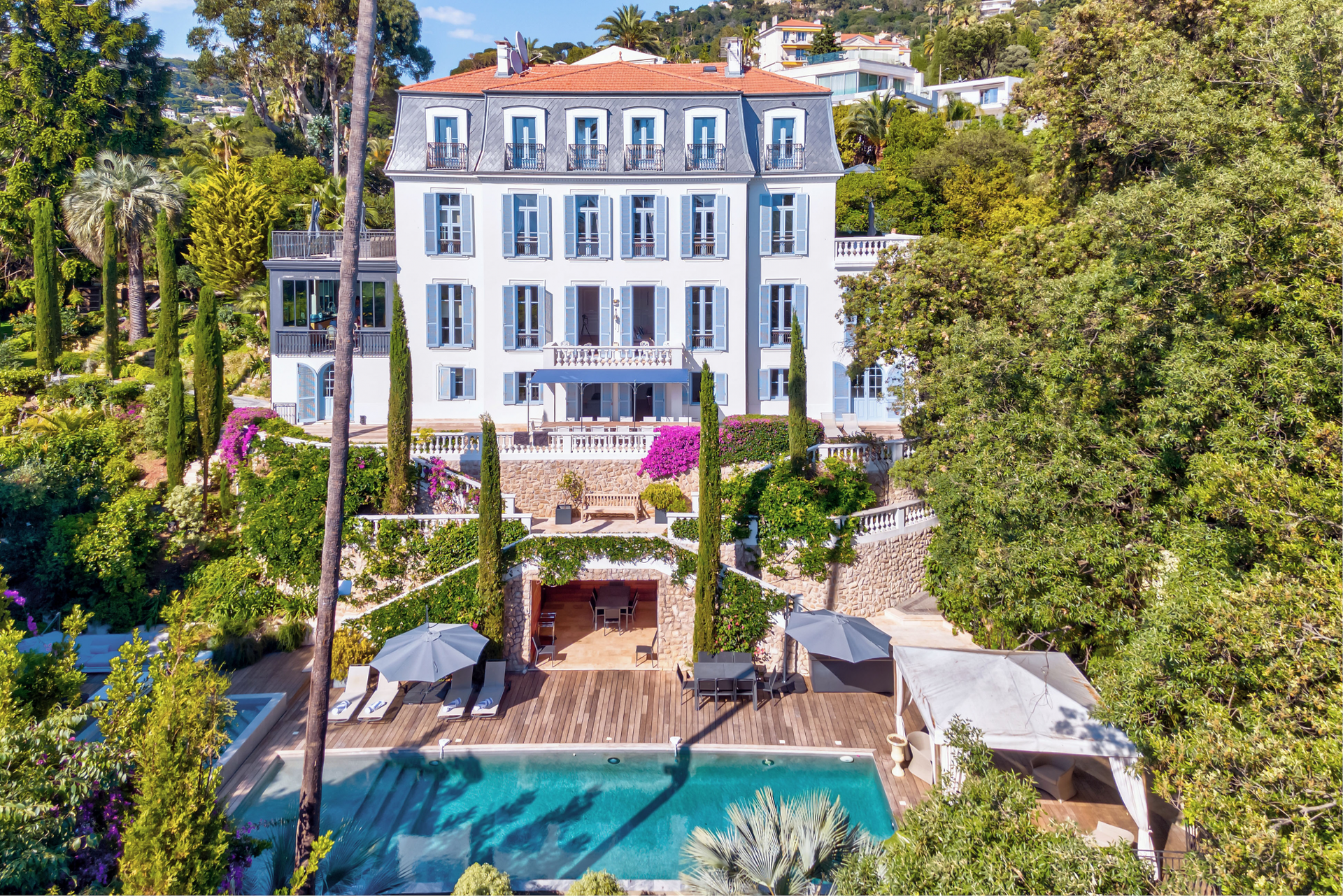 Aerial view of The Lark's Song, a Belle Époque villa in Cannes with a long infinity pool set among mature gardens