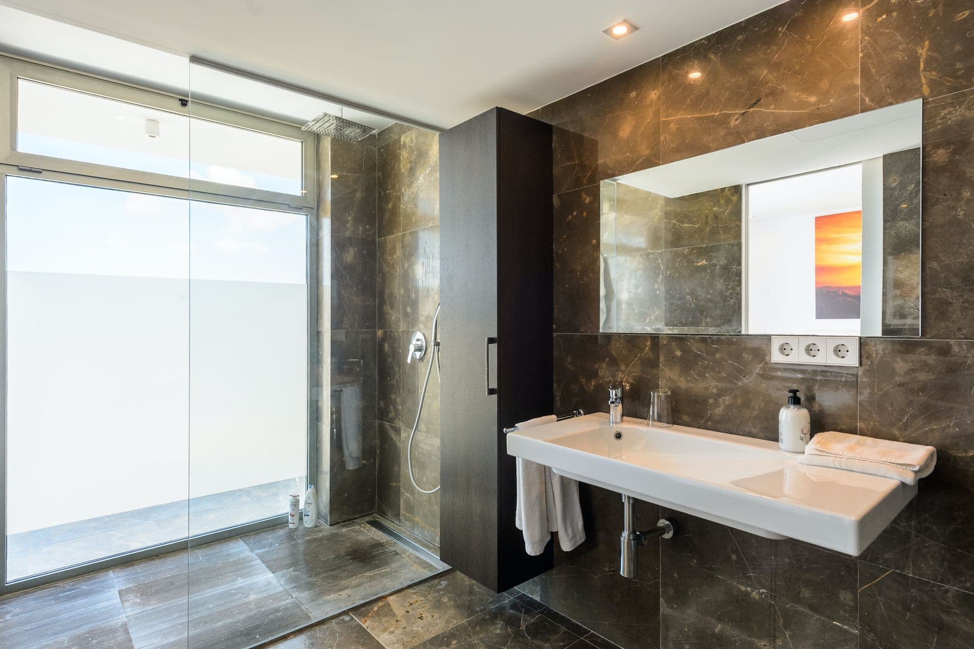 Bathroom with a marble double vanity and full wall mirror