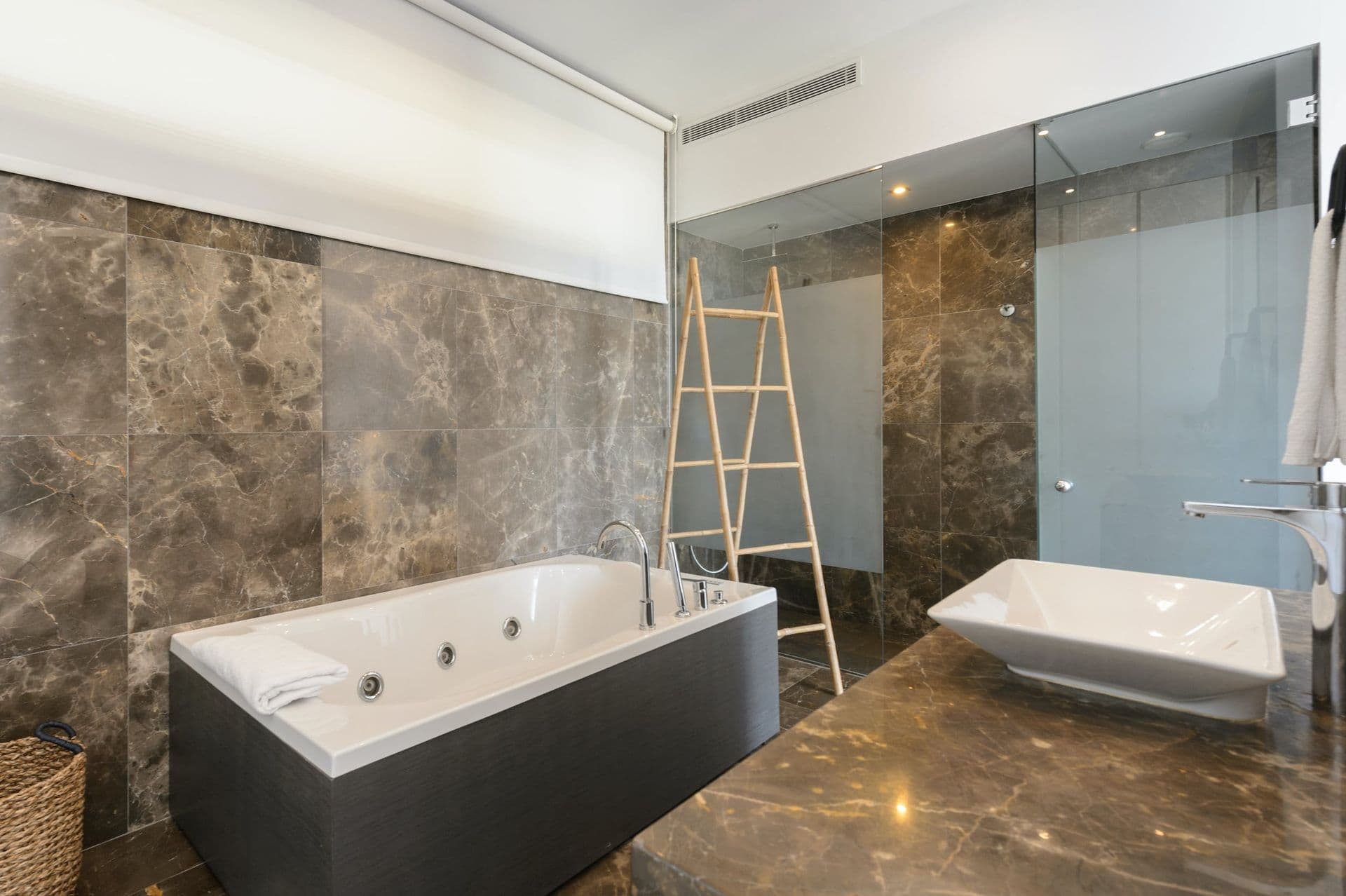 Marble en-suite bathroom with a freestanding jacuzzi bathtub
