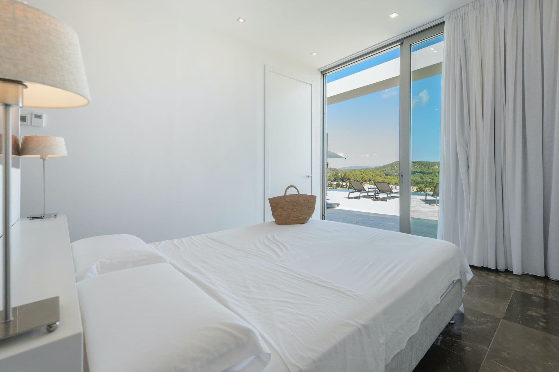Bedroom with a private balcony and panoramic hillside view