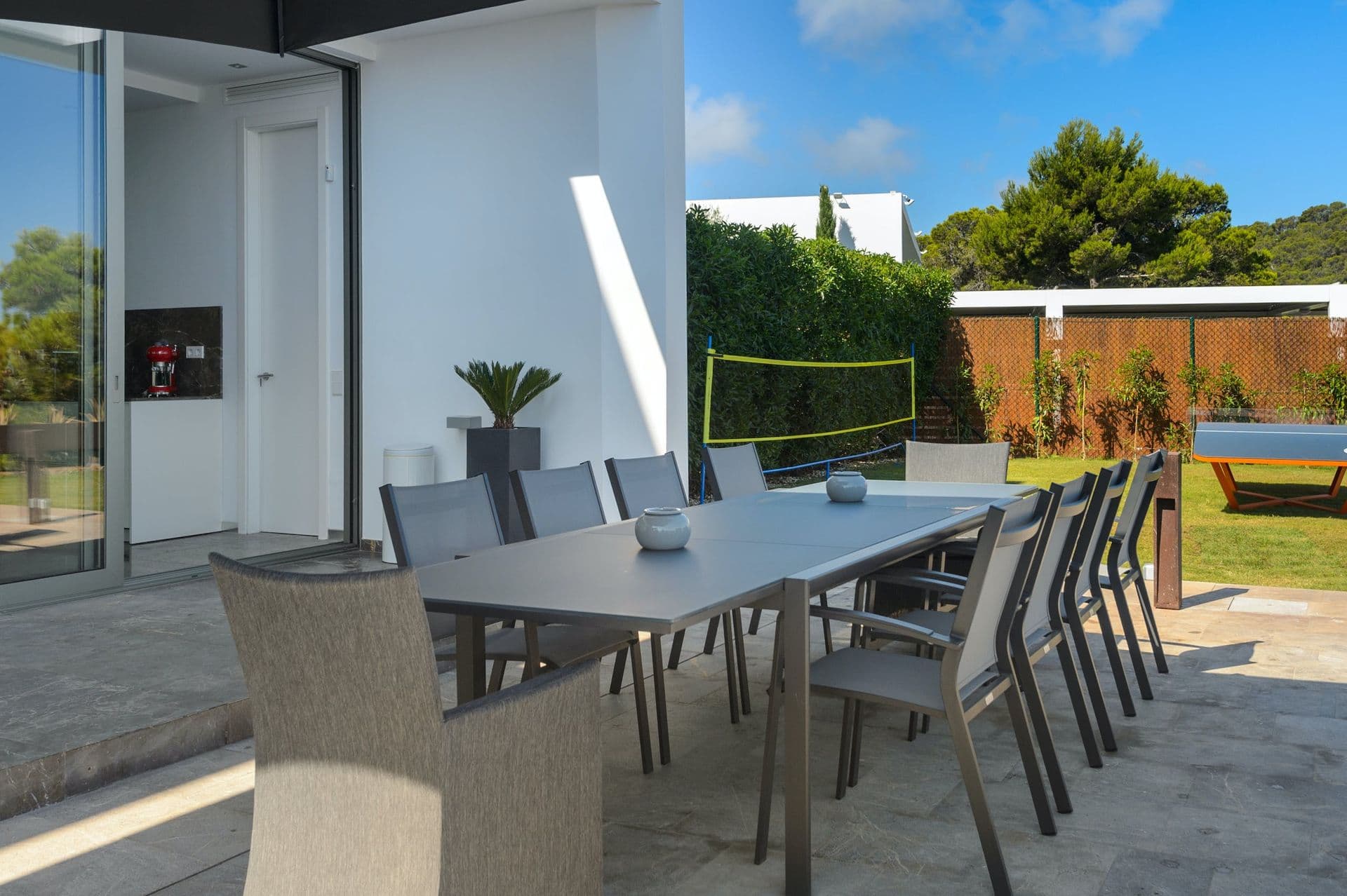 Outdoor dining table for ten on a terrace with hillside views