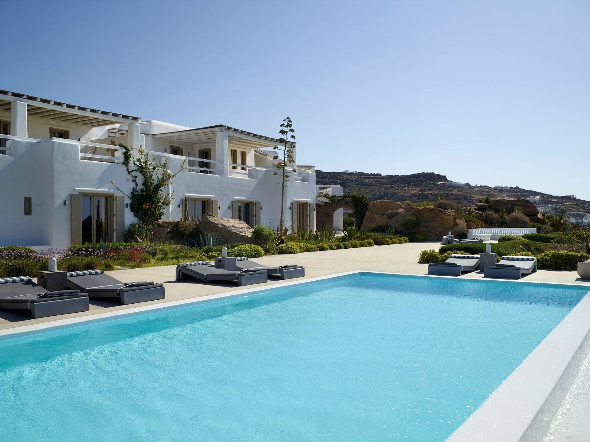 Cycladic style villa terrace with an infinity pool overlooking the sea.
