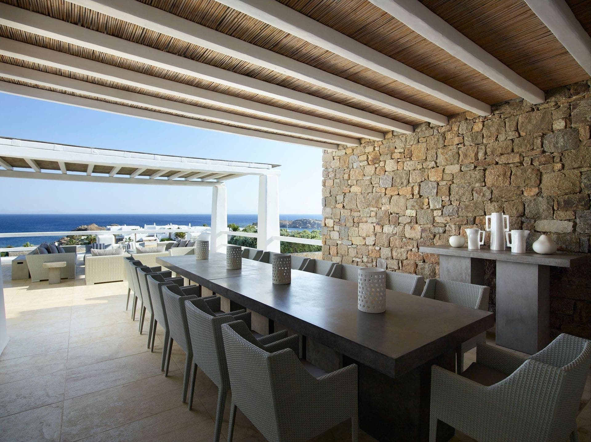 Long stone walled dining terrace seating over a dozen guests.
