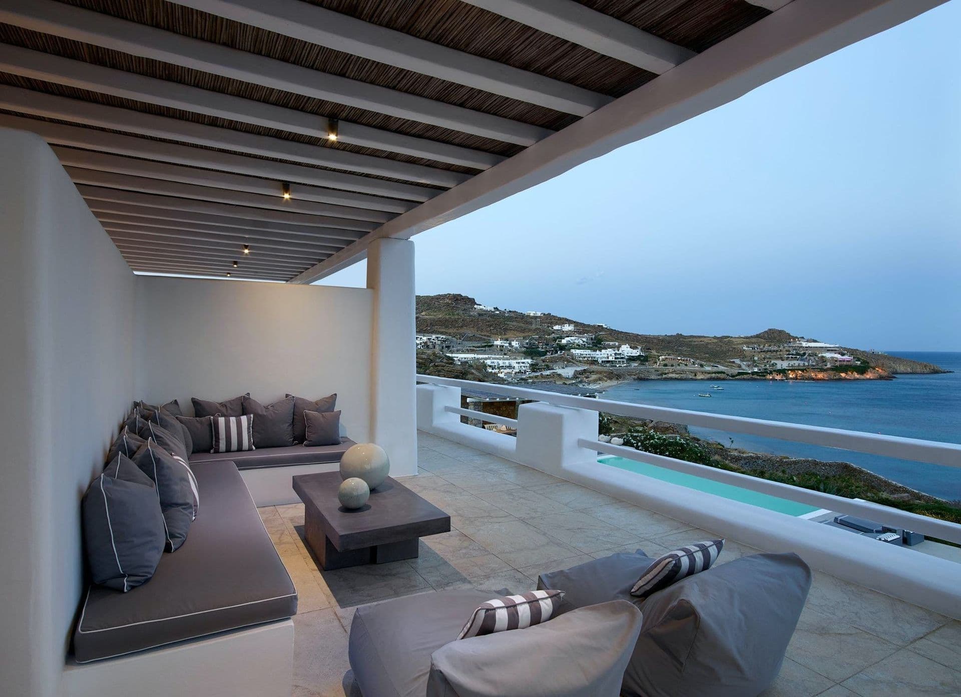 Corner lounge seating catching the sunset over the sea.