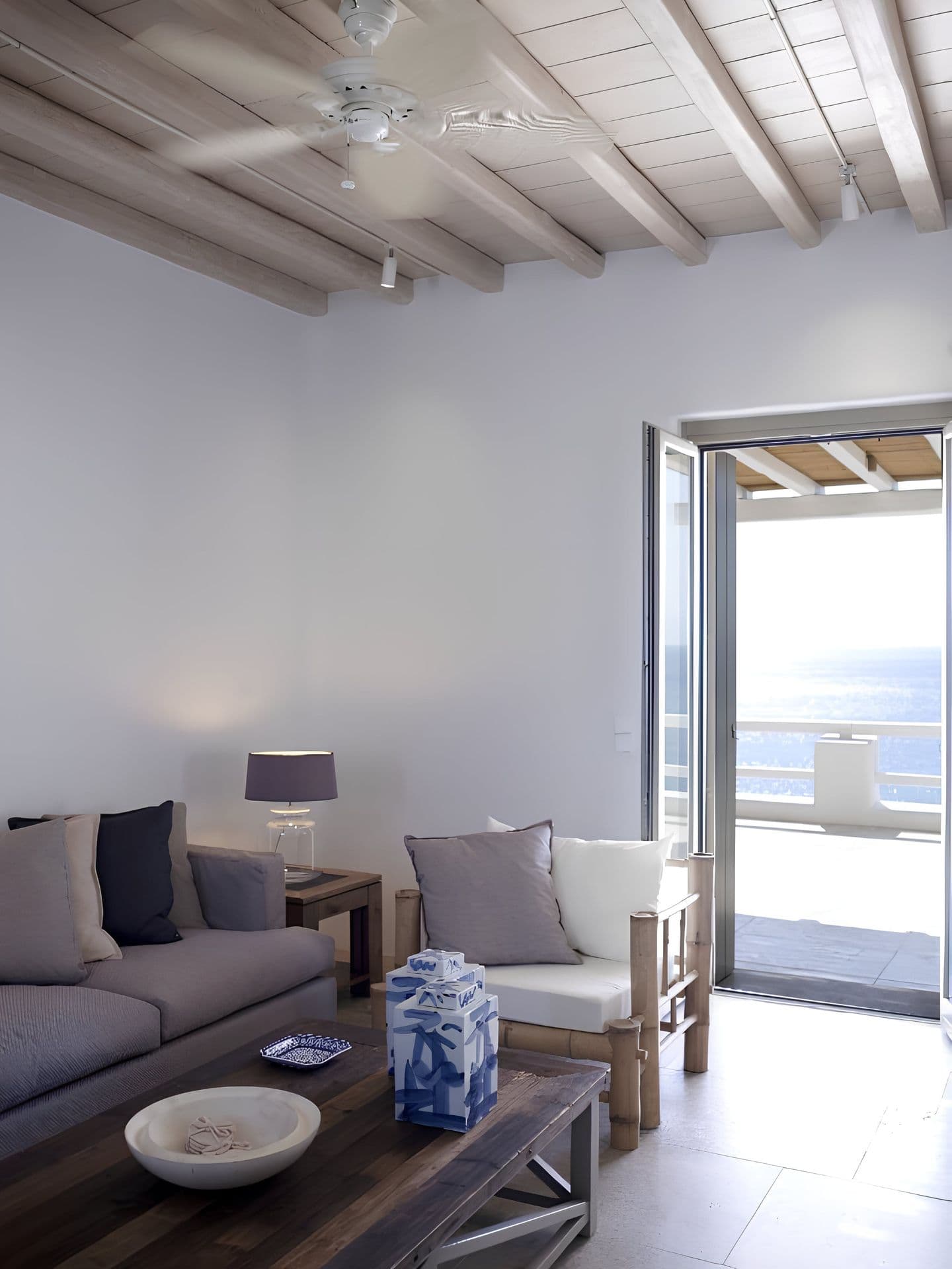 Hallway leading to a bedroom with a glimpse of the sea beyond.