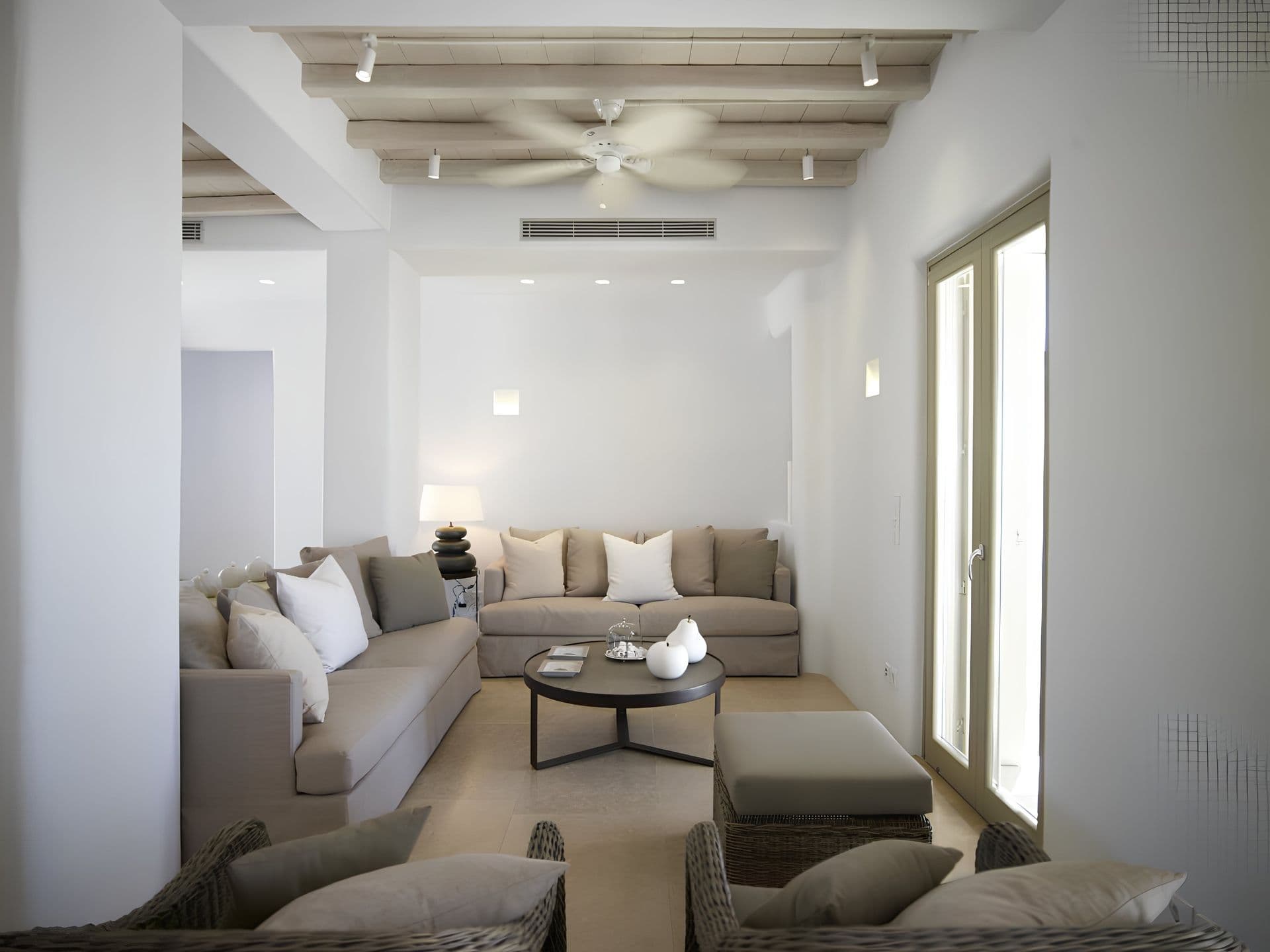 Living room with beige sofas and a round coffee table.