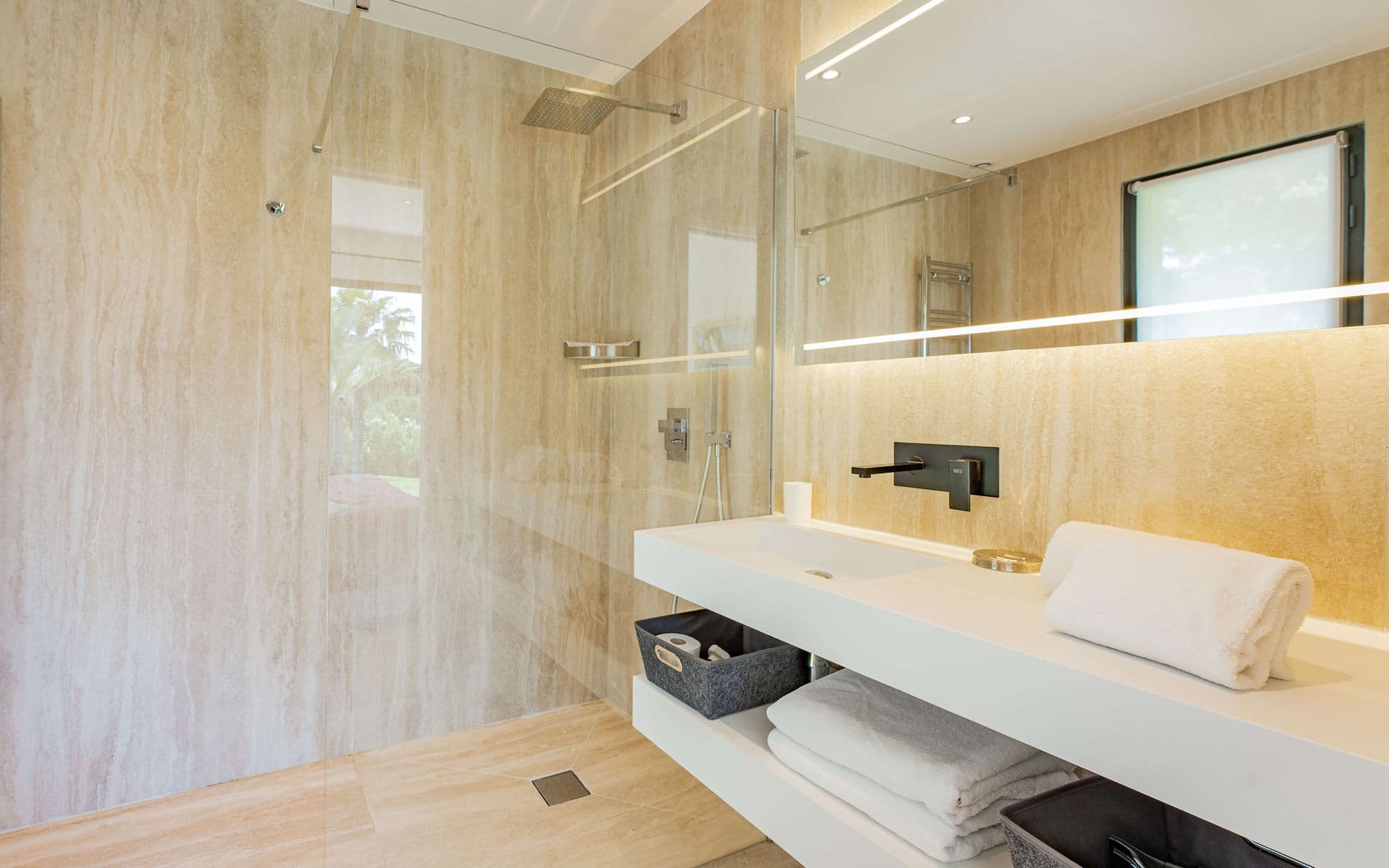 En-suite bathroom with a marble double vanity and folded towels.