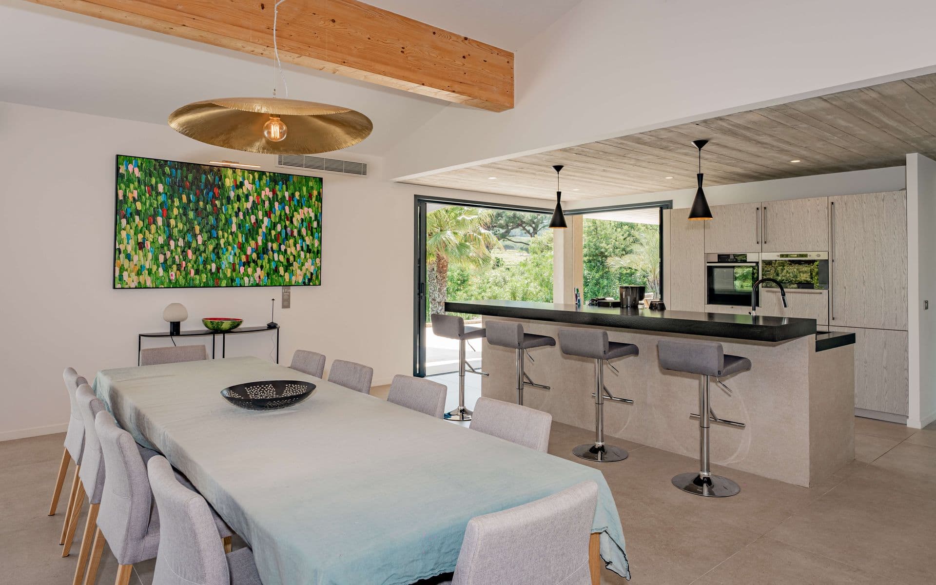 Open-plan kitchen with breakfast bar opening onto the dining area.