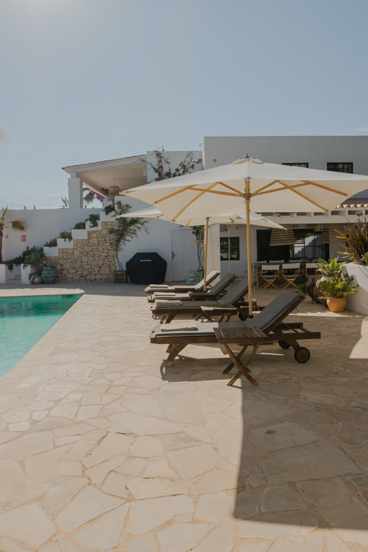 Whitewashed villa and swimming pool seen across the sun terrace at New Beat