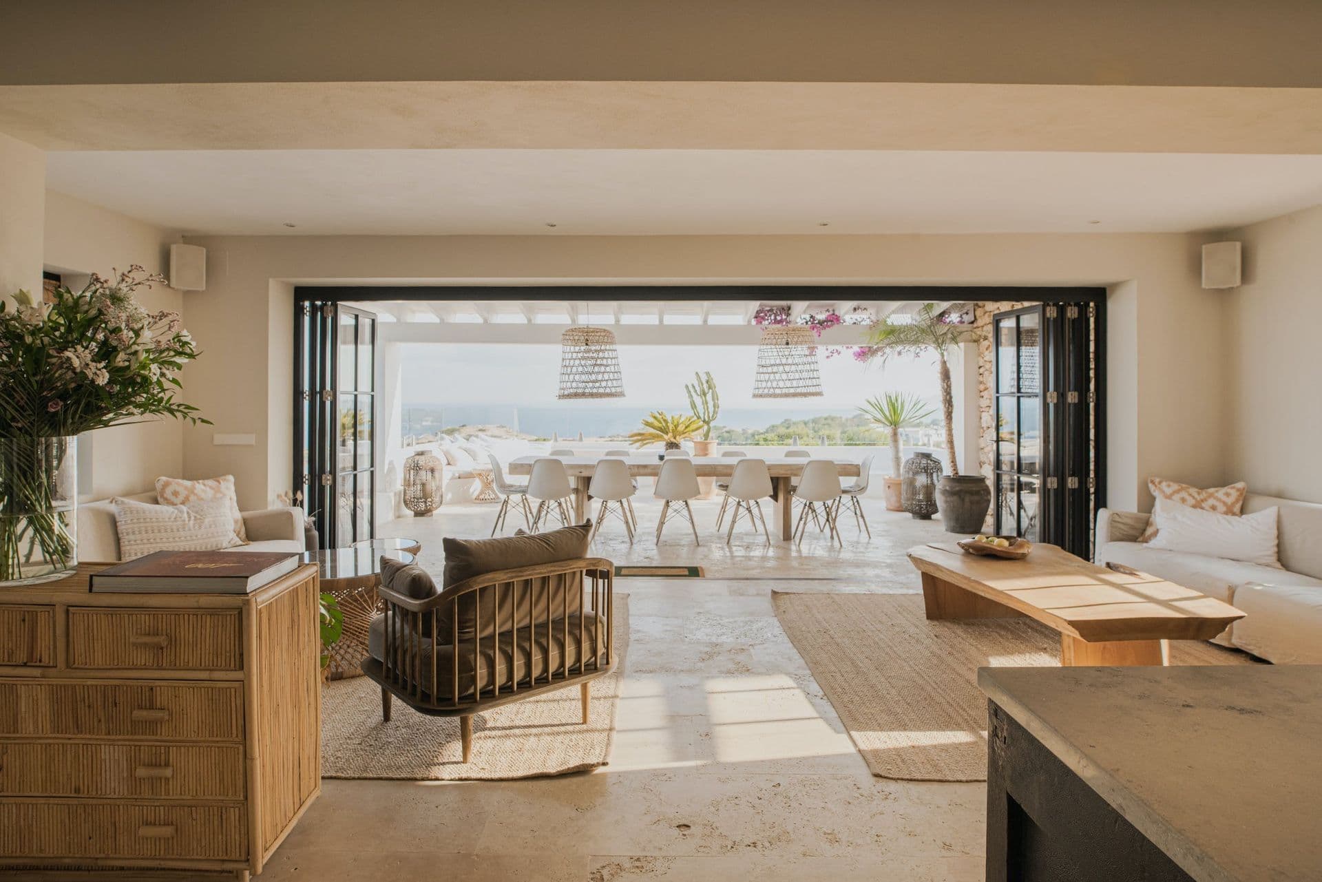 Living area flowing directly onto the covered terrace through wide glass doors at New Beat