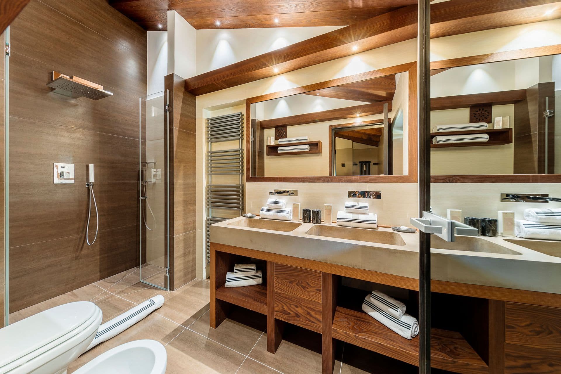 En-suite with a double timber vanity and walk-in shower at Dolomite Prestige, Cortina d'Ampezzo