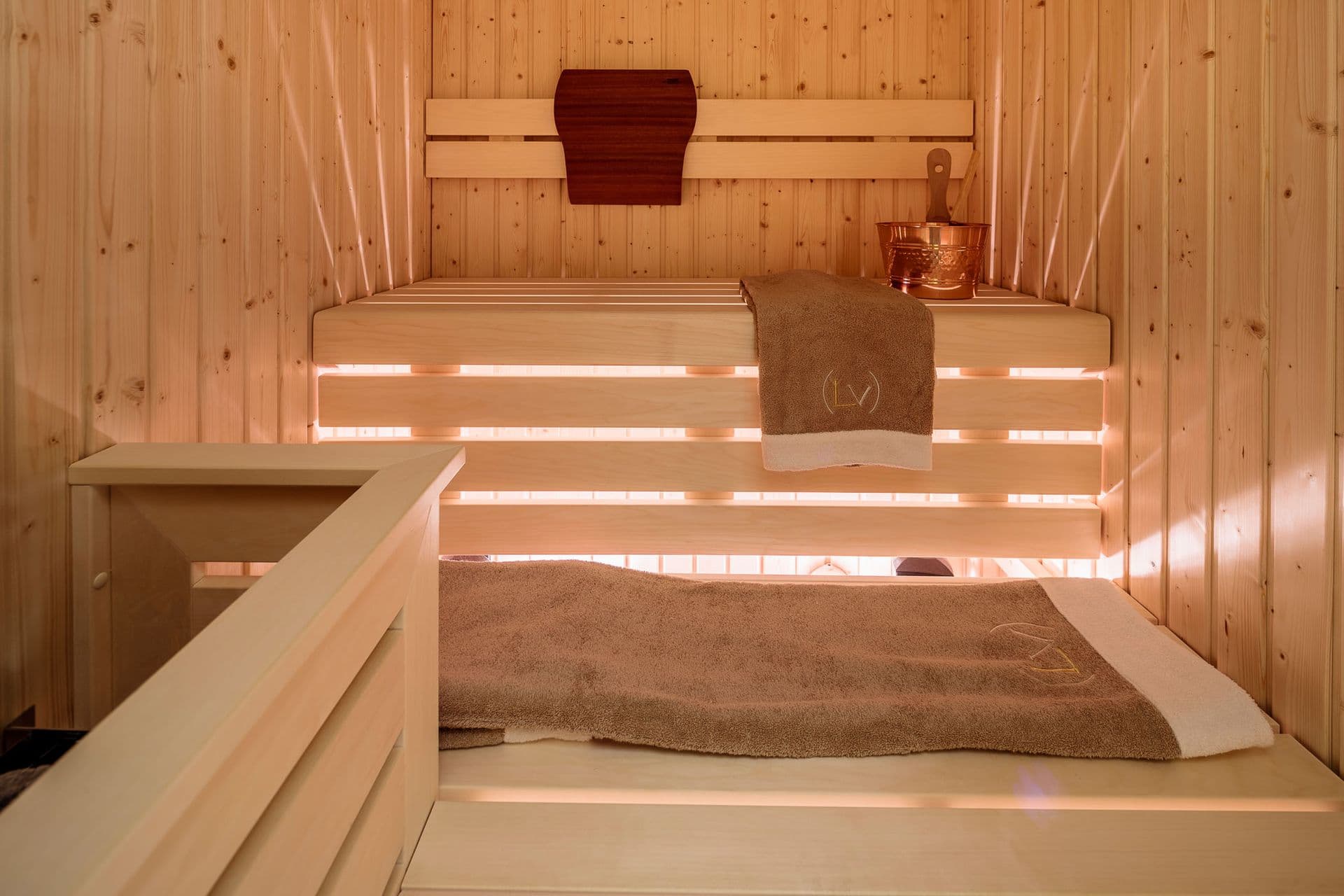 Timber sauna with backlit benches at Dolomite Prestige, Cortina d'Ampezzo
