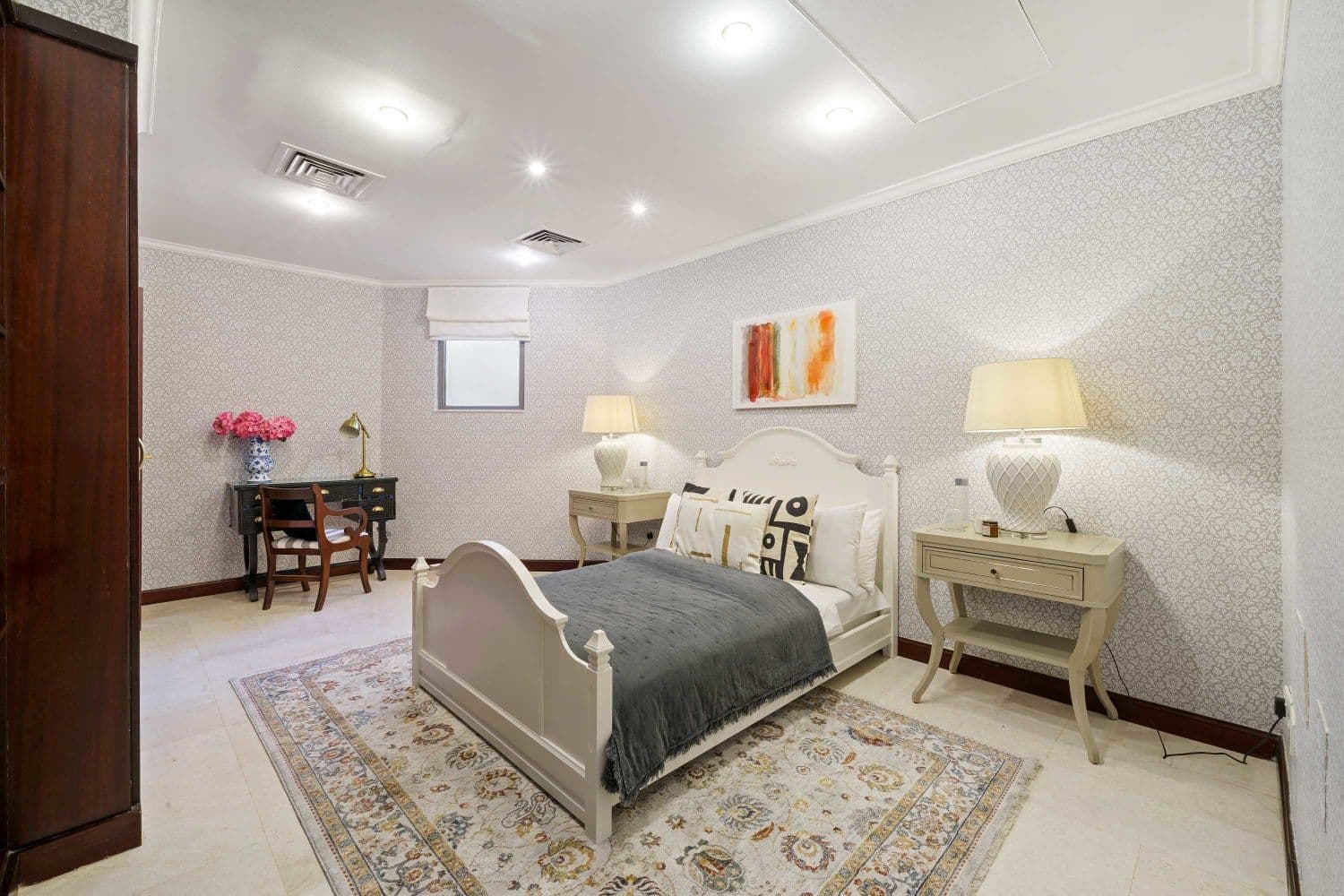 Double bedroom with a white sleigh bed and a patterned rug at A Place in the Palms, Palm Jumeirah