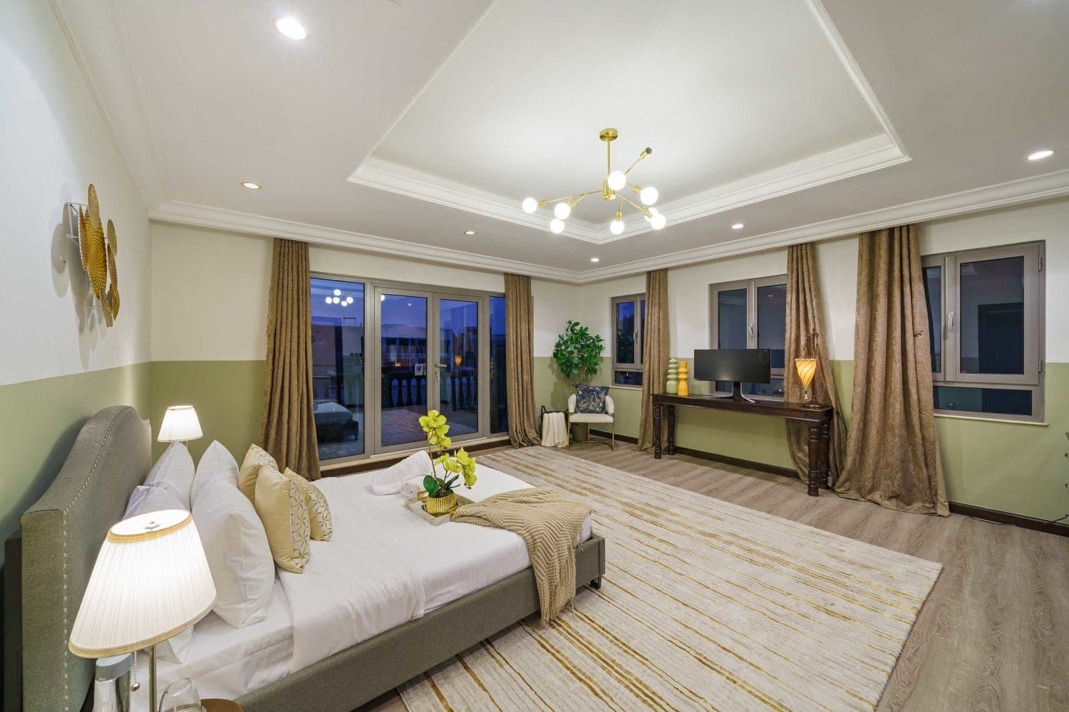 Double bedroom with a grey bed opening to a terrace at A Place in the Palms, Palm Jumeirah