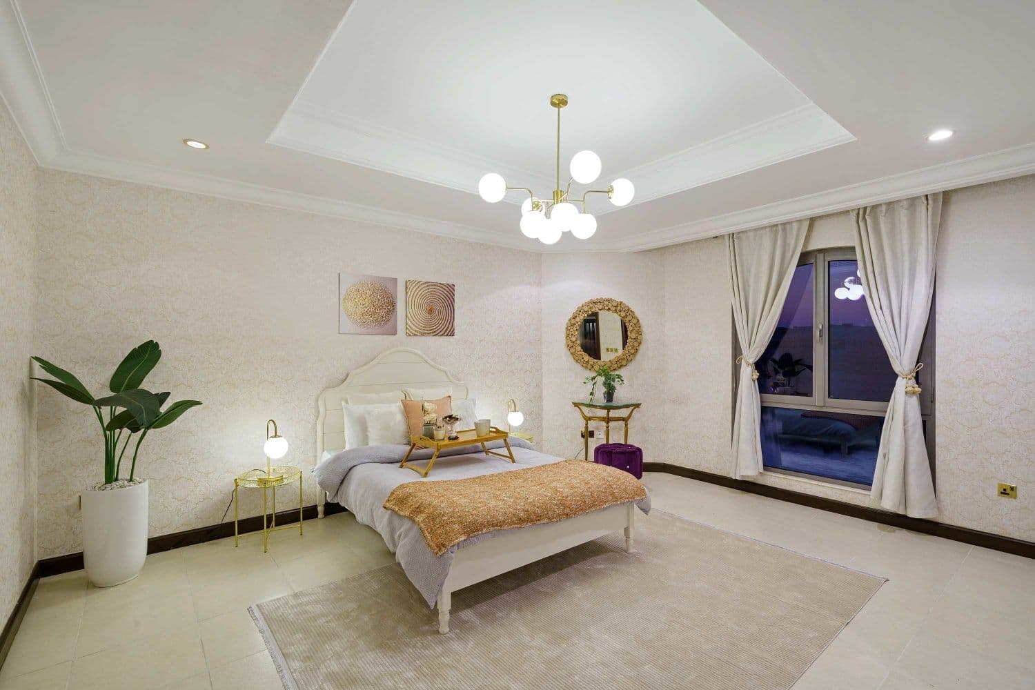 Double bedroom with an upholstered headboard and a framed mirror at A Place in the Palms, Palm Jumeirah