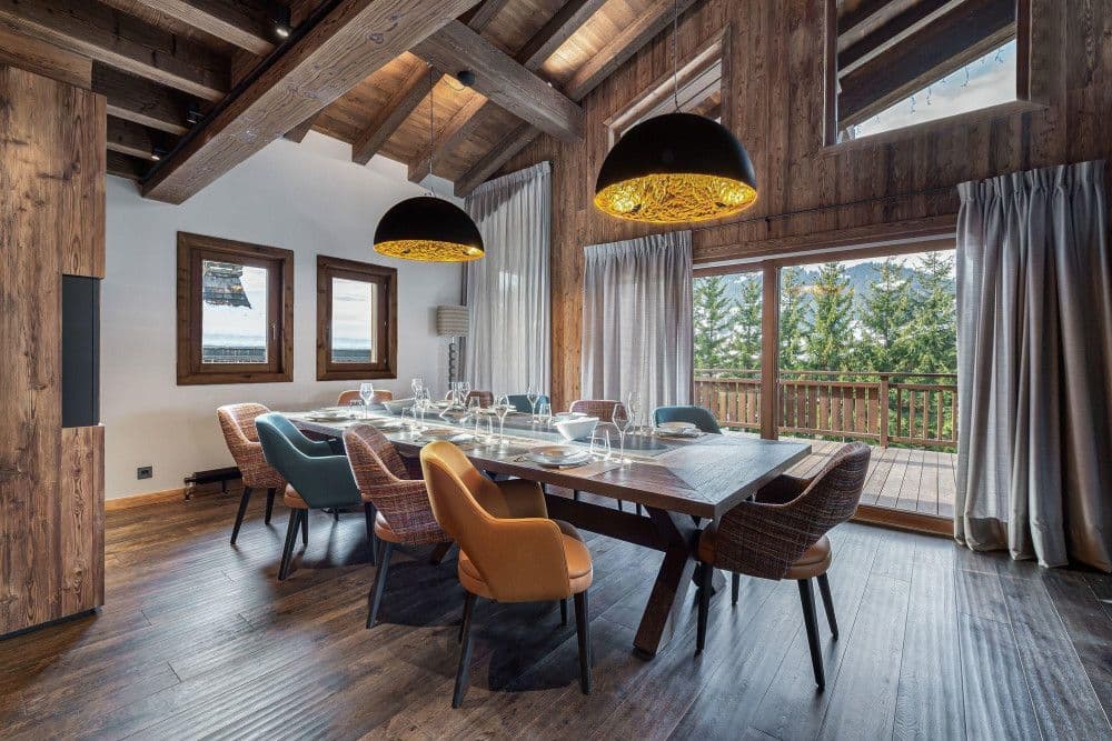Dining room opening to a terrace with mountain views at Mont d'Arbois 6
