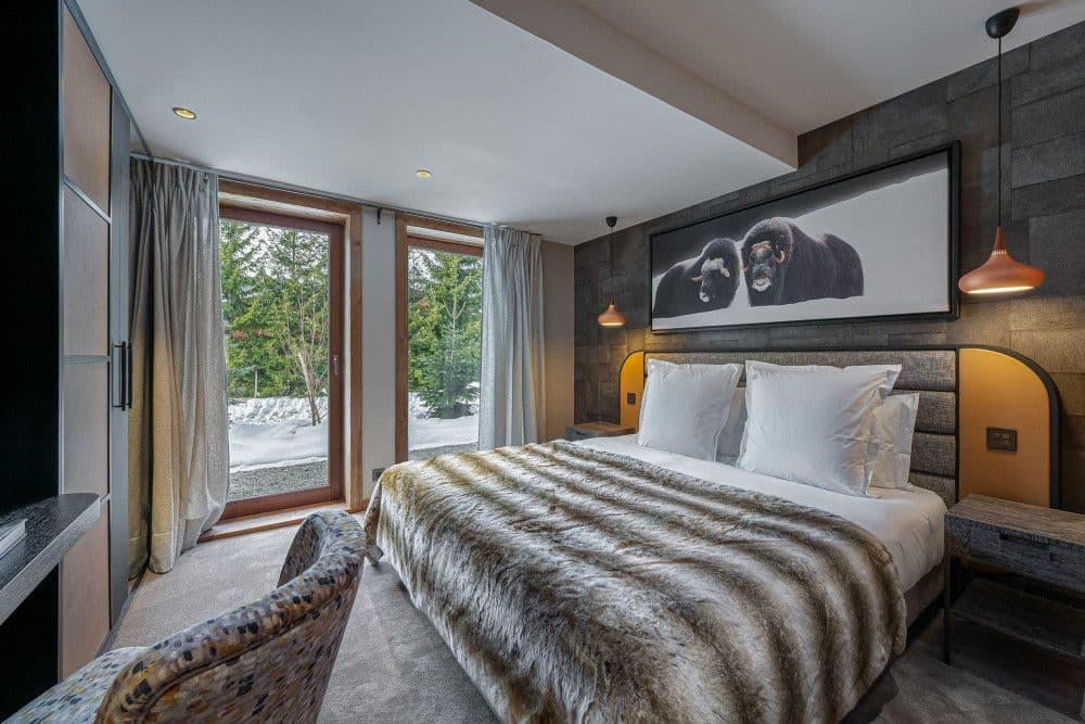 Double bedroom opening to the trees at Mont d'Arbois 6