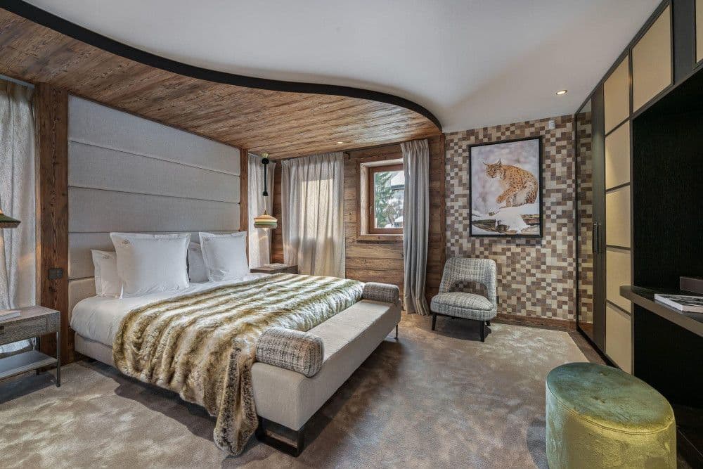 Guest bedroom with a mosaic feature wall at Mont d'Arbois 6