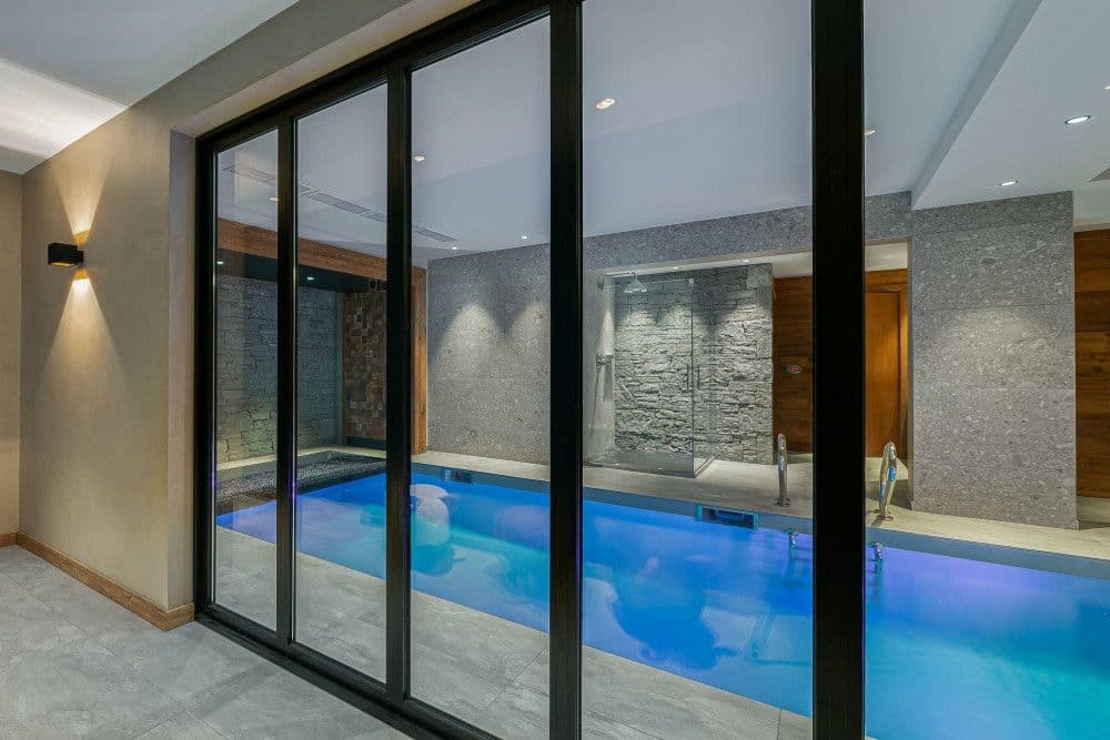 Indoor swimming pool behind glass at Mont d'Arbois 6