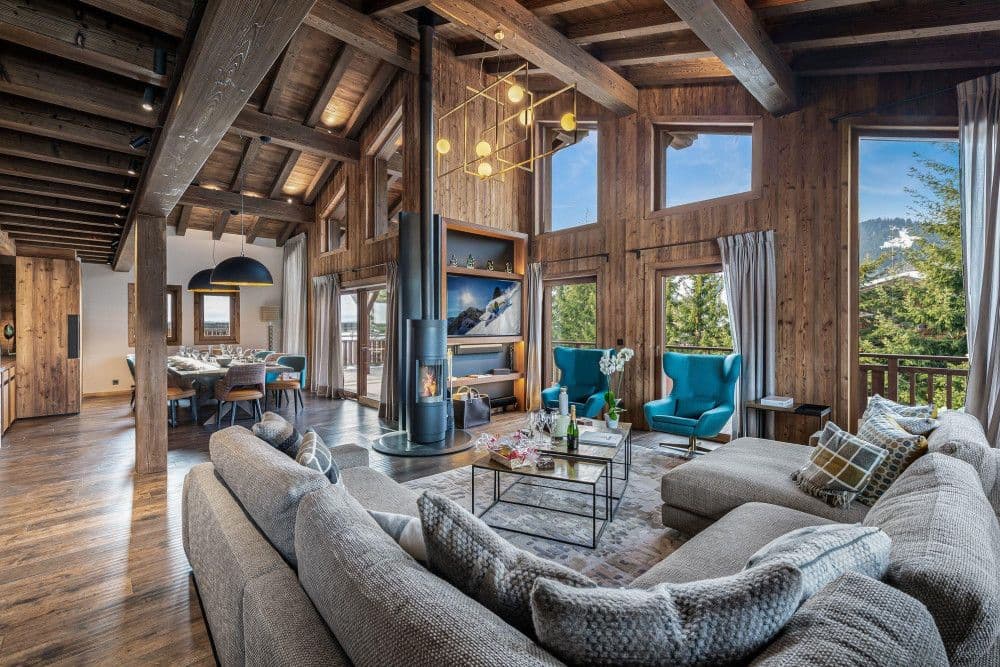 Fireside sitting room with a modern fireplace and armchairs at Mont d'Arbois 6