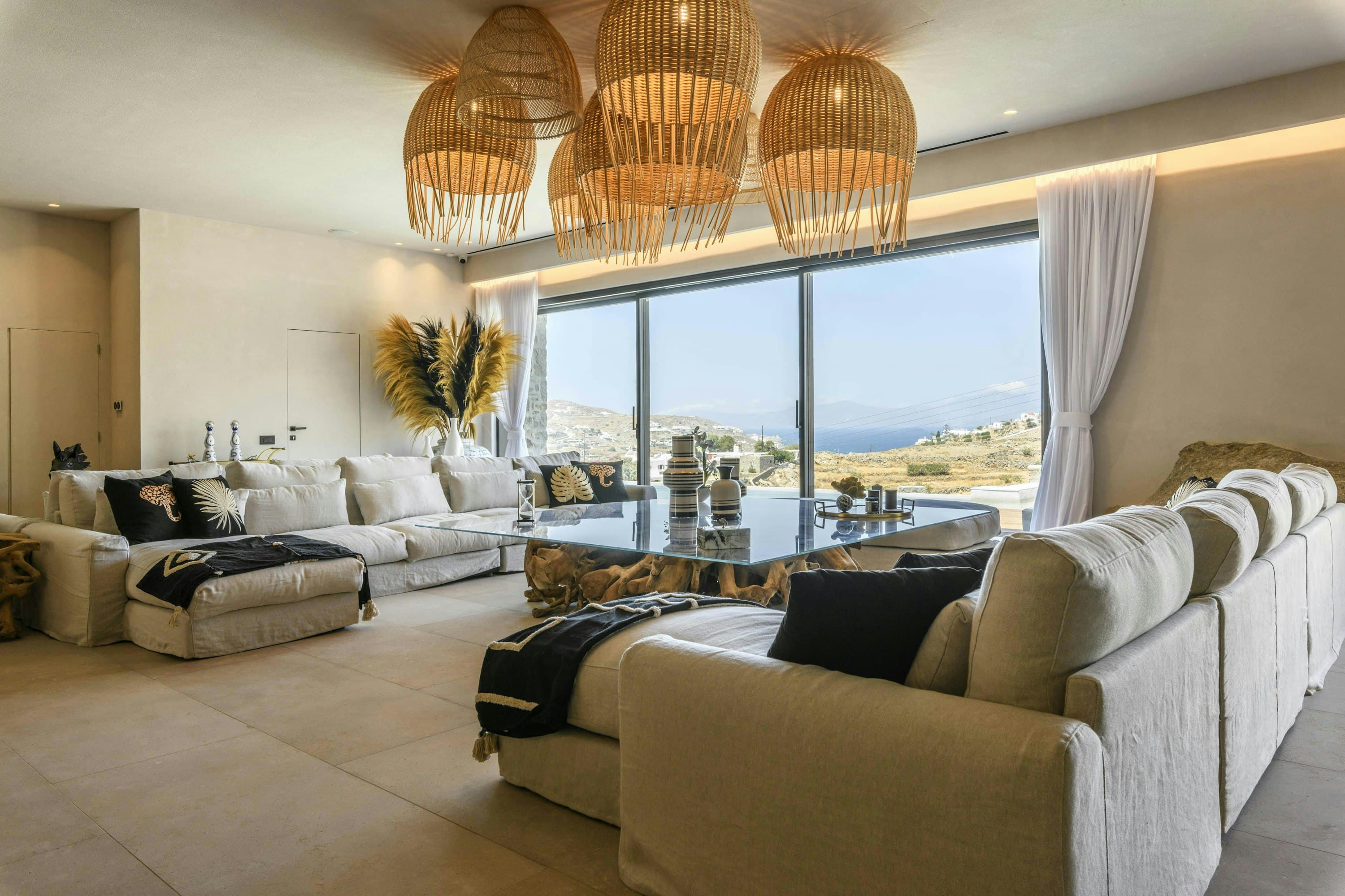 Grecian Sunset villa living room with glass doors and sea views, Psarou, Cyclades Islands, Greece