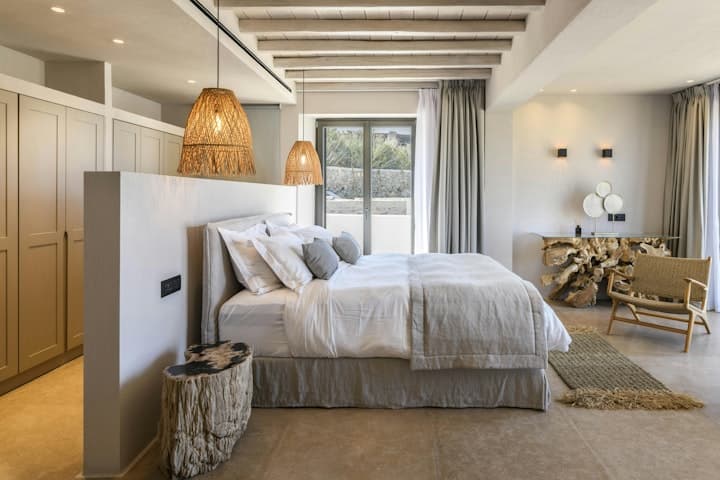 Grecian Sunset master bedroom with exposed beams and wicker lights, Psarou, Cyclades Islands, Greece