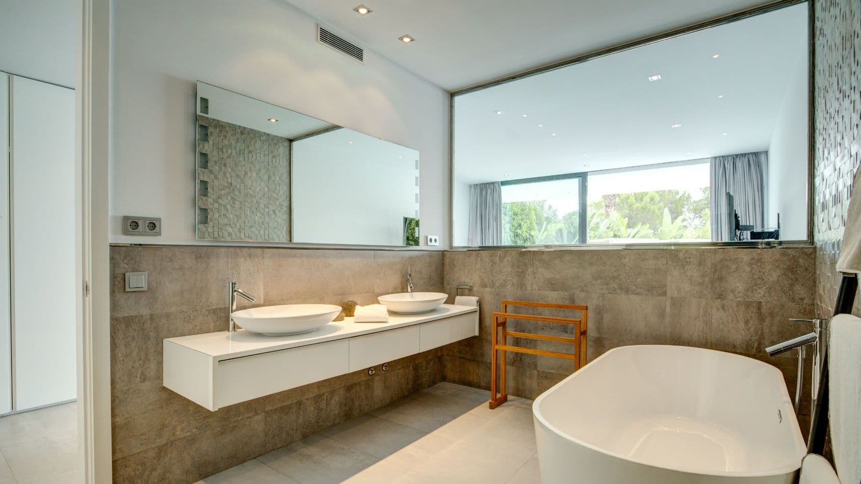 Bathroom with twin basins and a freestanding tub by a picture window at Baby, You Can Drive My Car, Ibiza
