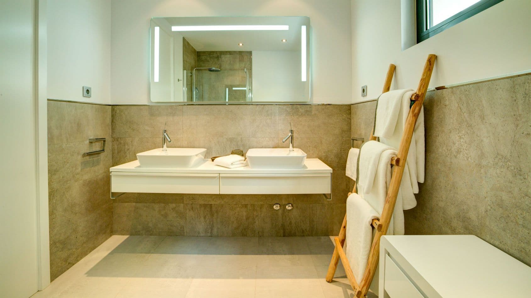 Bathroom with a floating double vanity and backlit mirror at Baby, You Can Drive My Car, Ibiza