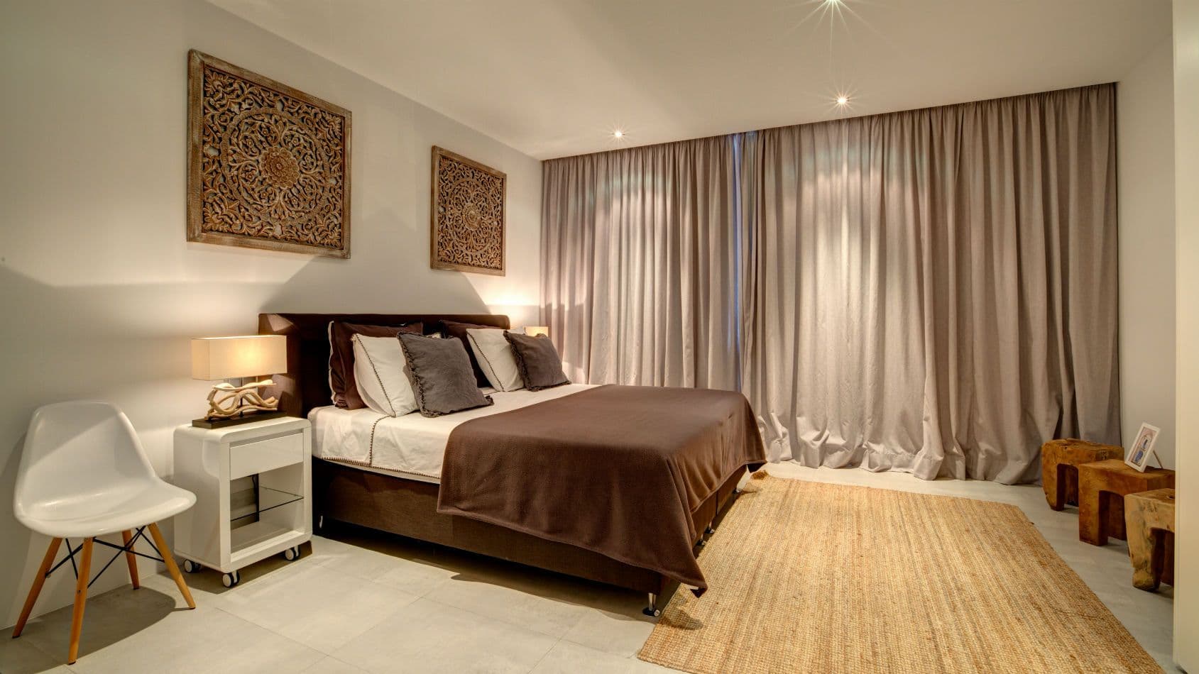 Double bedroom with carved wood panels and floor-length curtains at Baby, You Can Drive My Car, Ibiza