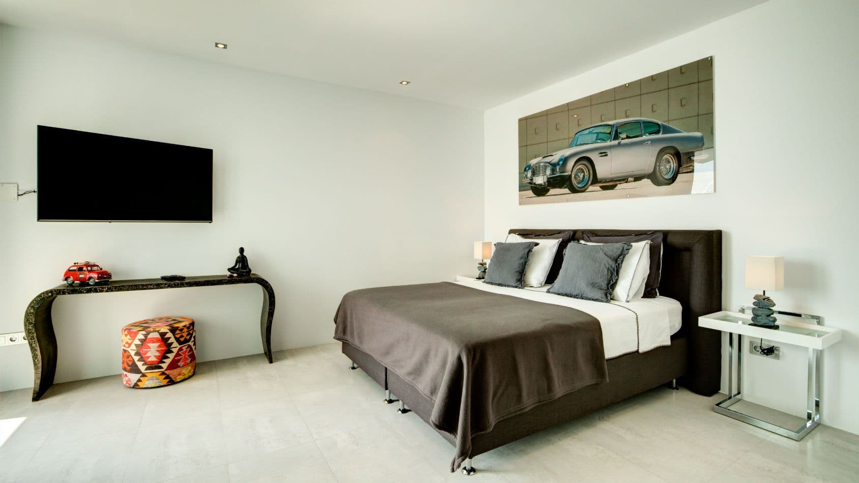 Double bedroom with a classic sports-car artwork above the bed at Baby, You Can Drive My Car, Ibiza