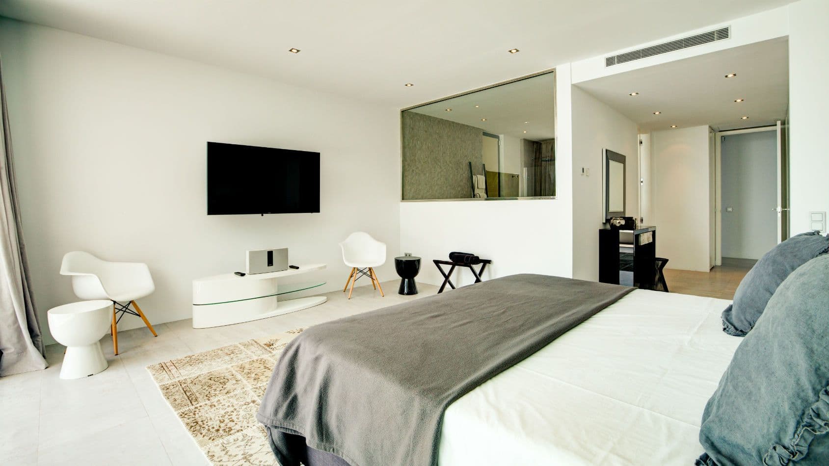 Double bedroom with a television and designer chairs at Baby, You Can Drive My Car, Ibiza