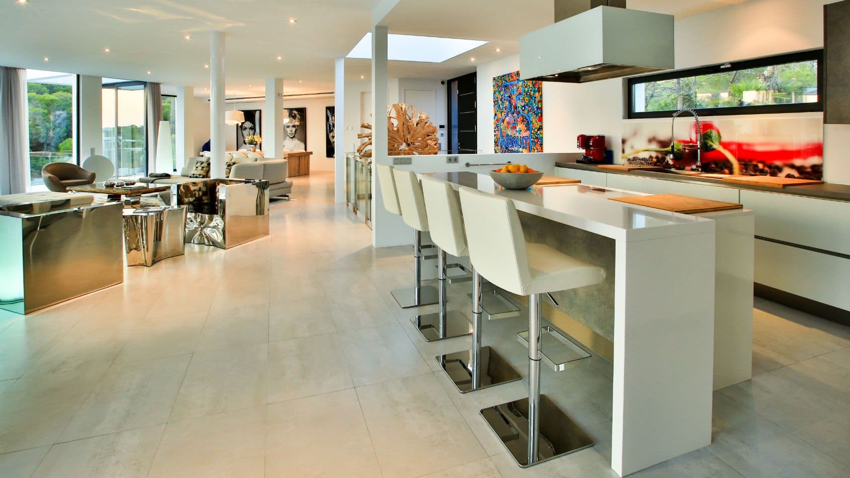 White gloss kitchen with an island breakfast bar and mirror-chrome units at Baby, You Can Drive My Car, Ibiza