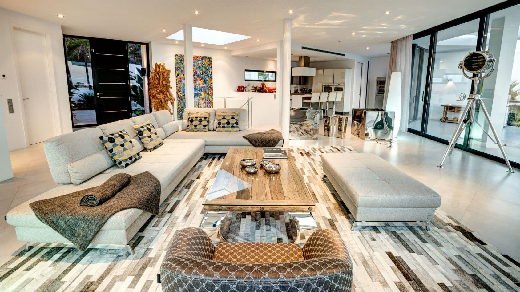 Reception lounge with a large modular sofa and bold artwork at Baby, You Can Drive My Car, Ibiza