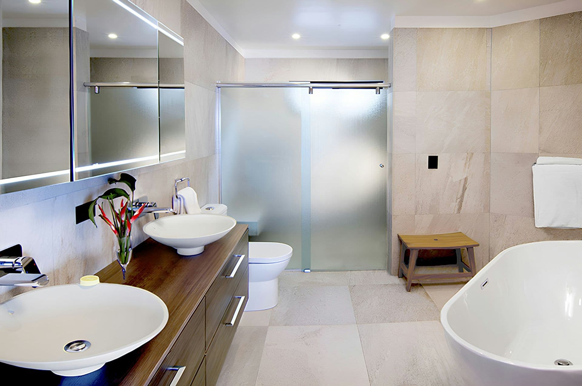 En-suite bathroom with a double vanity, freestanding bath and walk-in shower at Hills of Antigua