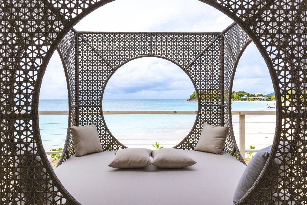 Circular screened daybed framing the sea view at Hills of Antigua