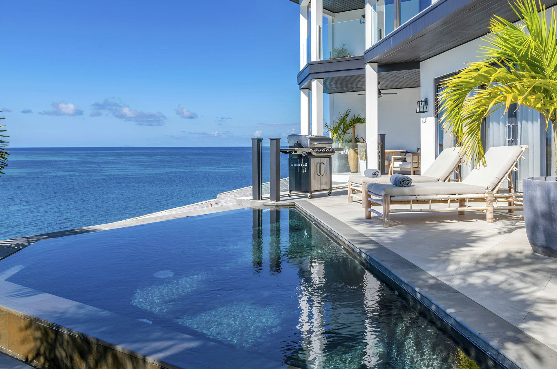 Infinity saltwater pool and terrace overlooking the Caribbean Sea at Hills of Antigua