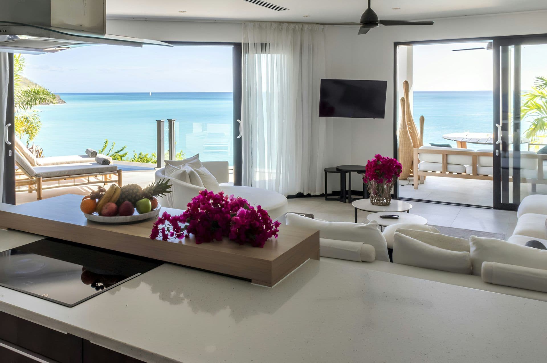 Open-plan living and dining space with sea views at Hills of Antigua