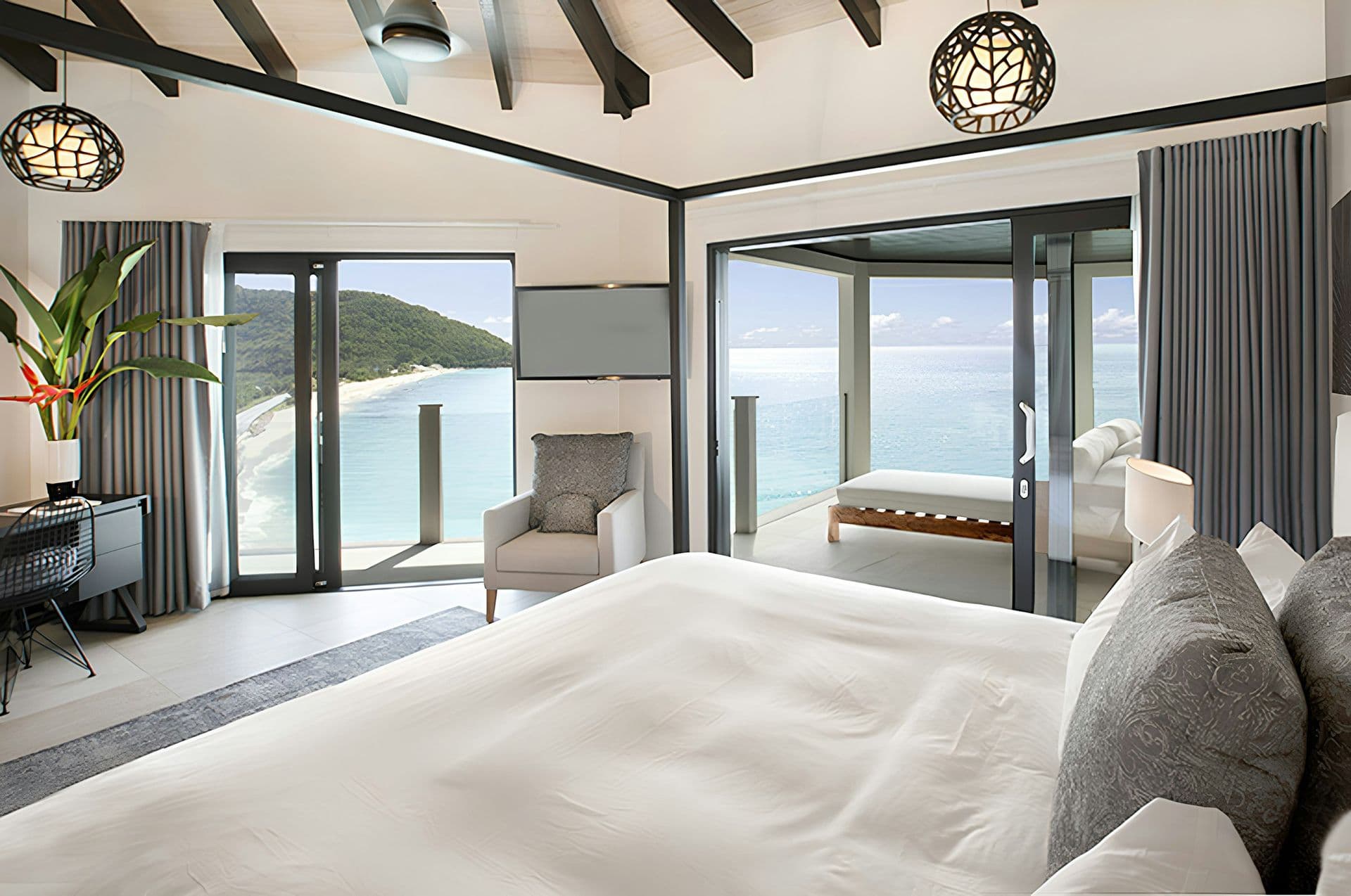 Master bedroom opening to a sea-view balcony at Hills of Antigua
