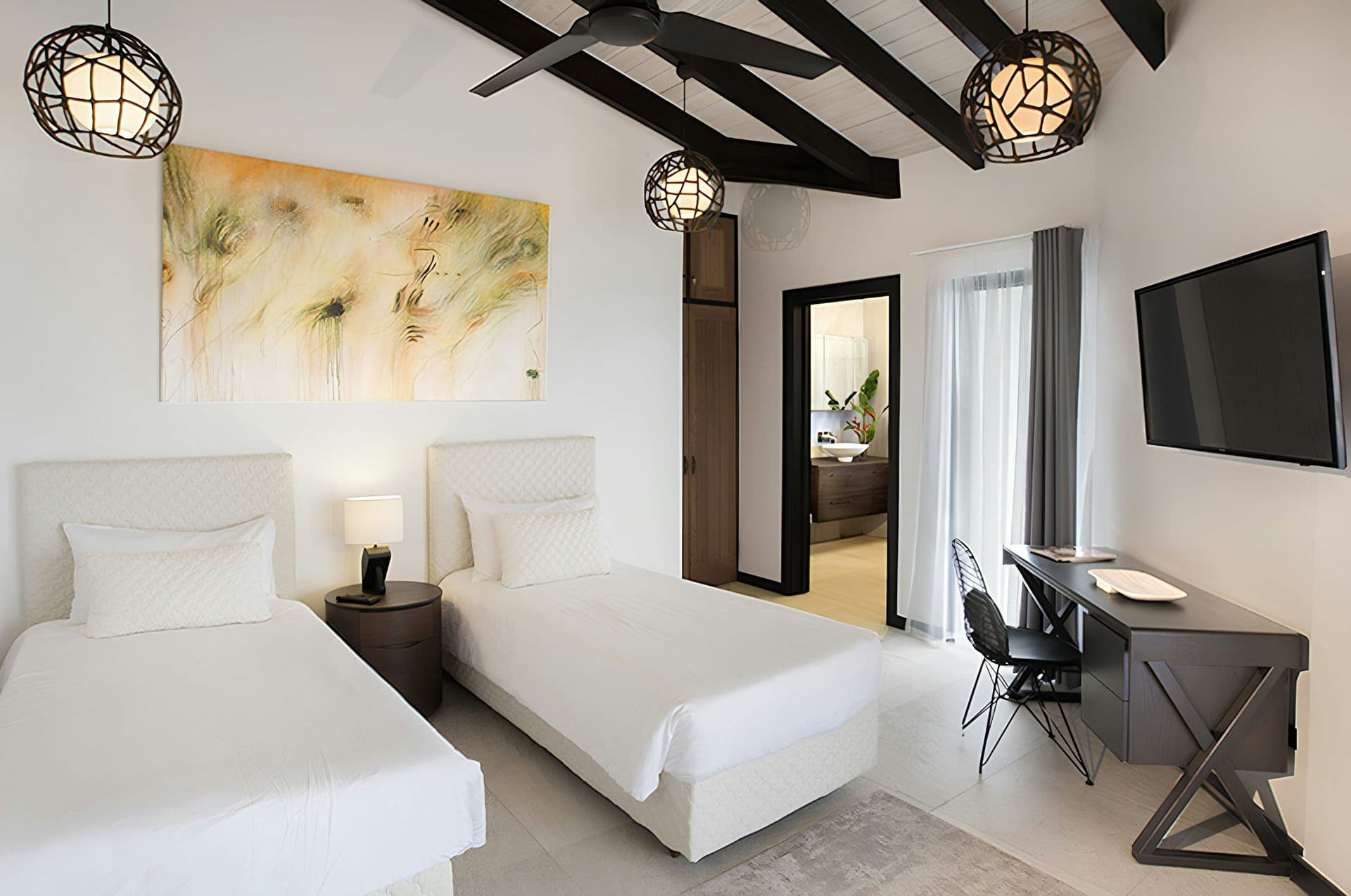 Twin bedroom under a beamed ceiling at Hills of Antigua
