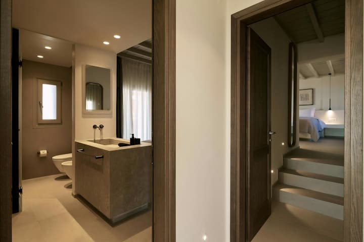 Sea Washed Wonder ensuite bathroom with concrete vanity, Mykonos, Greece
