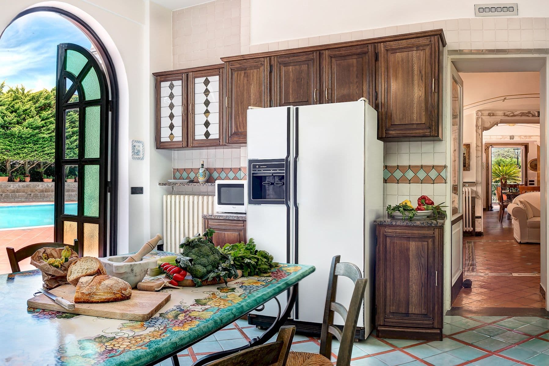 Traditional kitchen with wood cabinetry and an integrated fridge freezer.