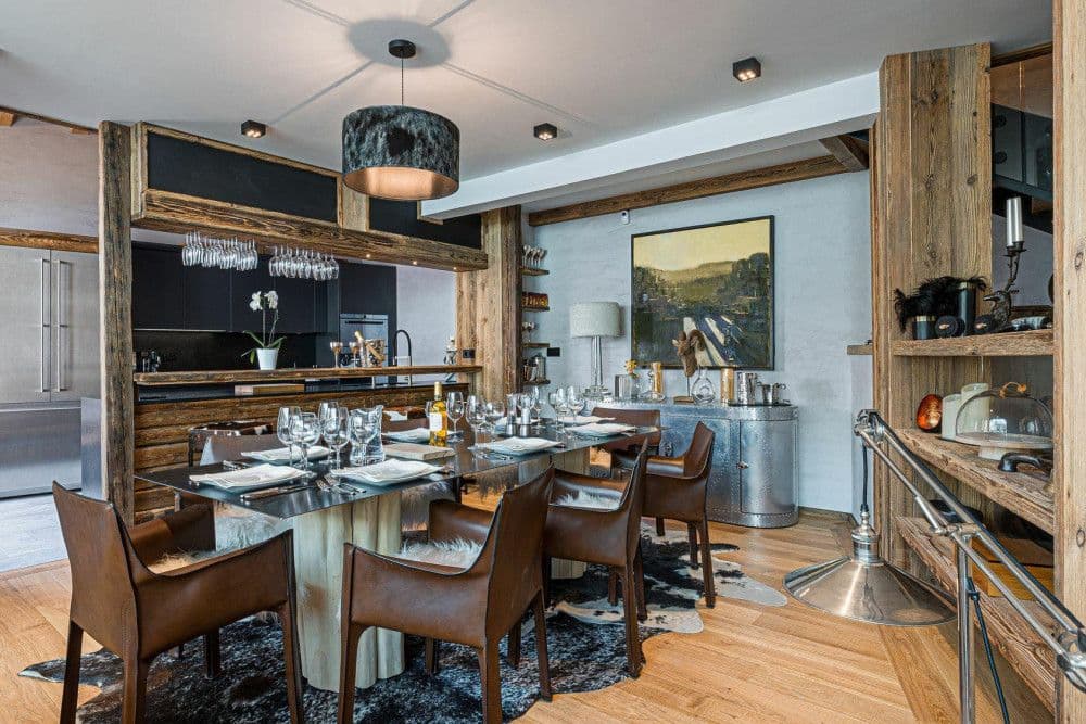 Dining table for the full party in a timber-lined room at Le Fornet 2