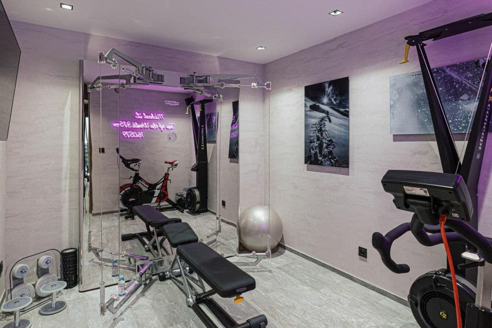 Home gym with cardio equipment and free weights at Le Fornet 2