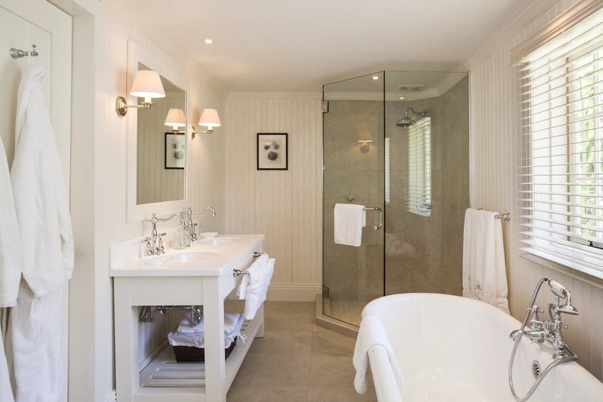 En-suite bathroom with double vanity, walk-in shower and roll-top bath at Caribbean Wonder
