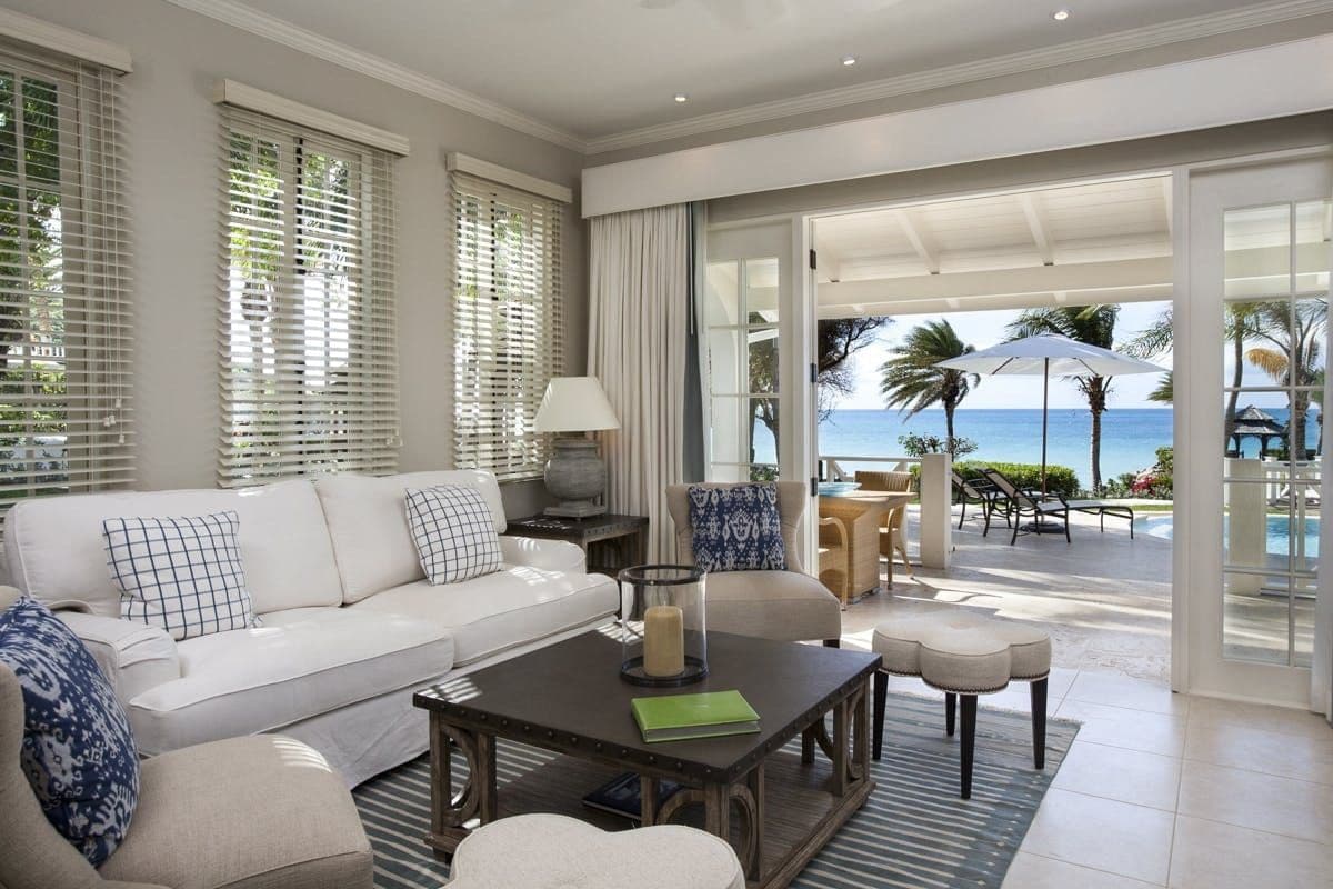 Open-plan living room in white opening to the terrace and sea at Caribbean Wonder