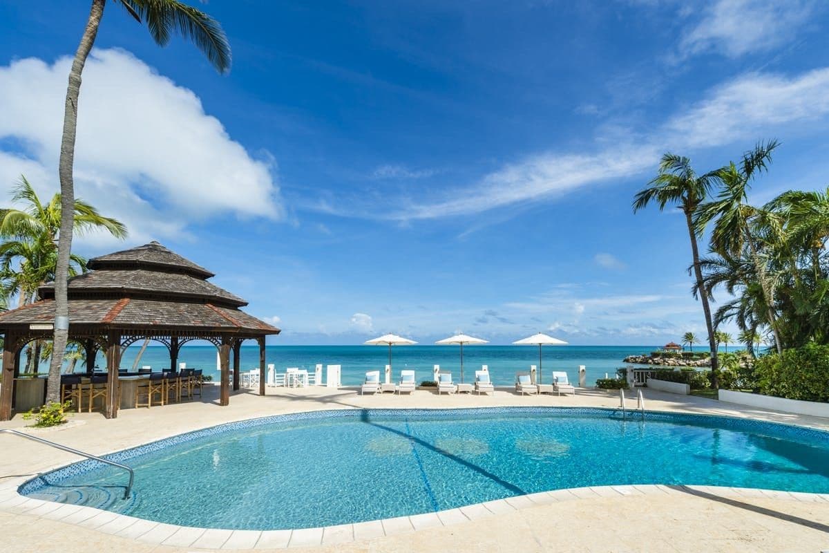 Private pool with a gazebo bar overlooking the white-sand beach and turquoise sea at Caribbean Wonder, Antigua
