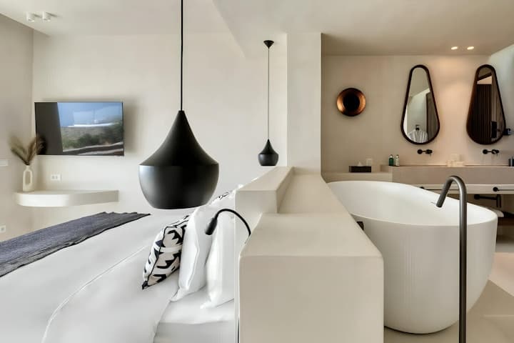 Aegean Beauty ensuite bathroom with freestanding tub and arched mirrors, Mykonos, Greece