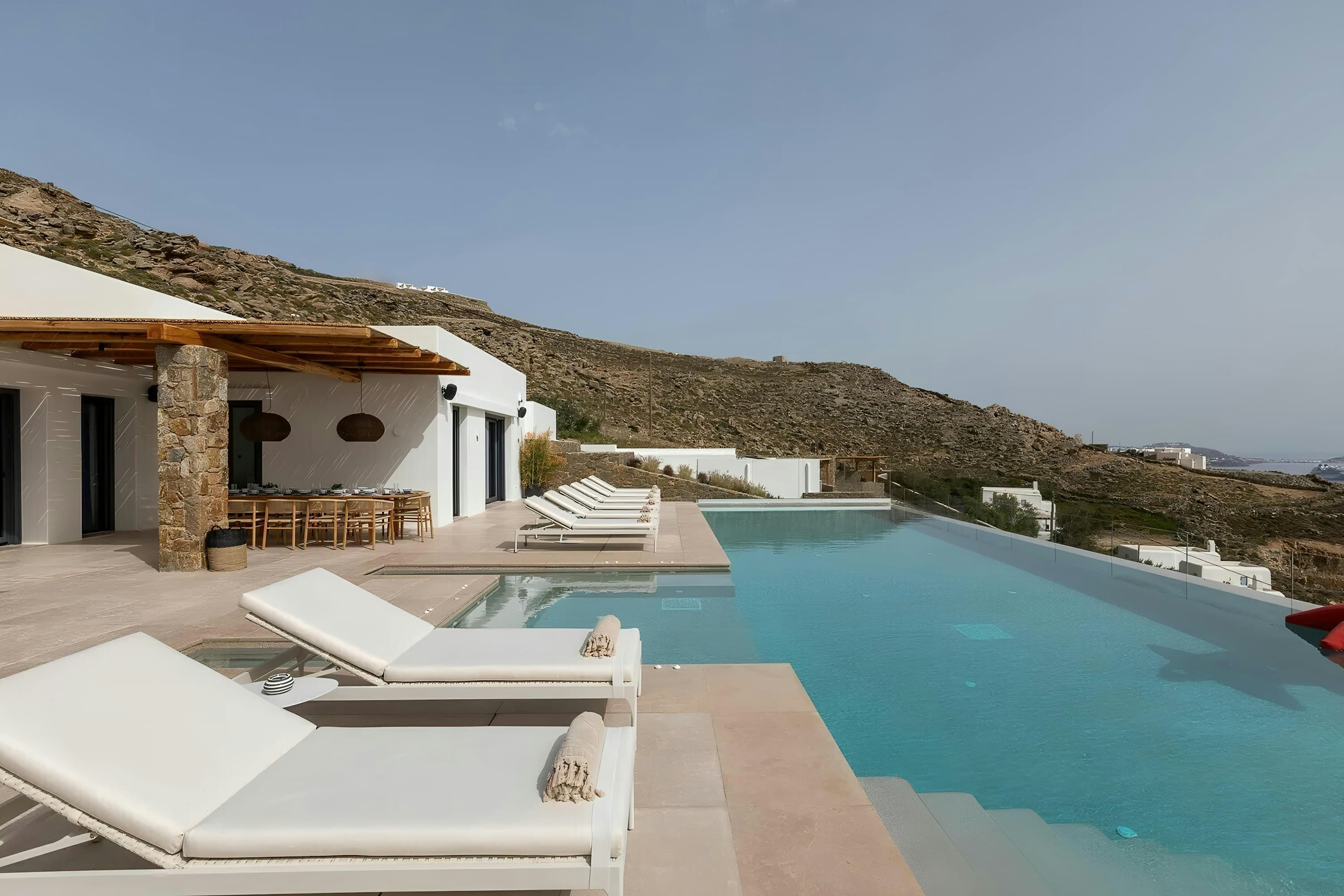 Aegean Beauty villa exterior with infinity pool and hillside views, Mykonos, Greece