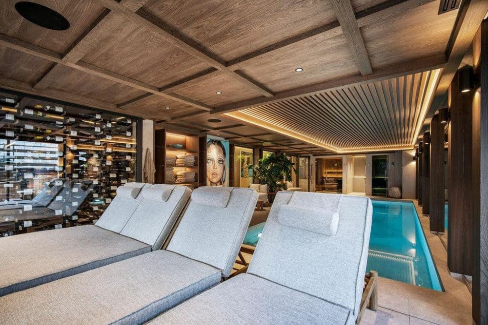 Spa loungers beside the pool and a wine display at Saint Martin de Belleville 12