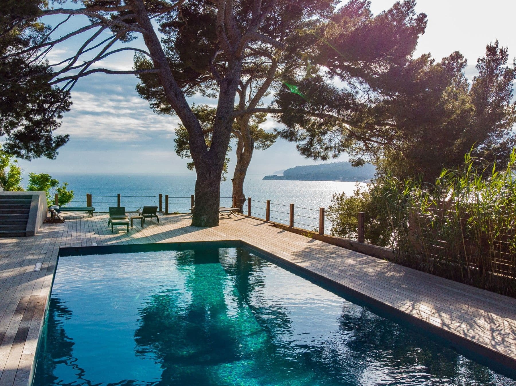 Pool shaded by a large pine looking out over the Mediterranean at Be Our Guest, Cassis, France